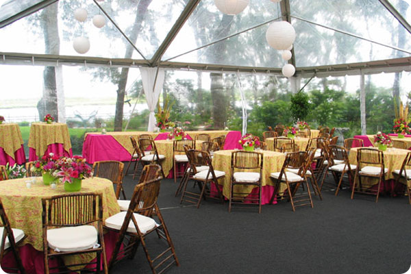 Bamboo chairs with pink and paisley table linens for wedding reception