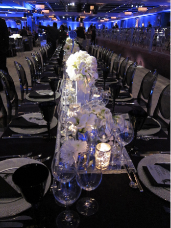 white flowers with black linens and black ghost chairs