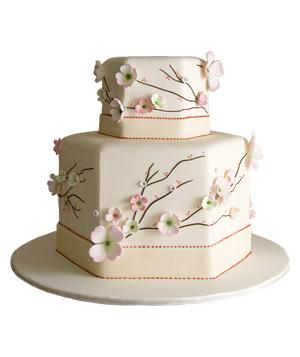 Hexagon shaped wedding cake with flowers cherry blossoms