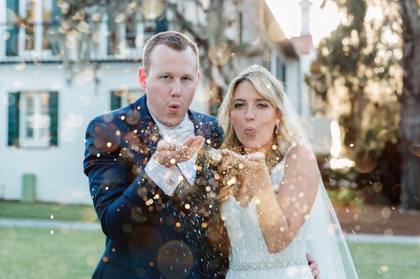 bride and groom blowing gold glitter at the Jekyll Hotel Club